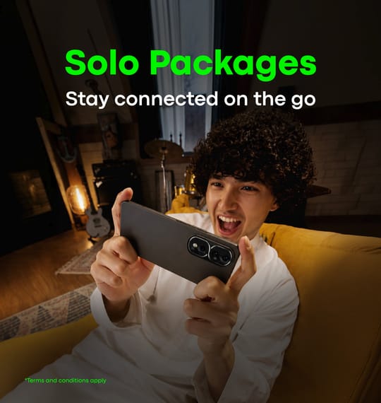 A boy playing a game on his phone using unlimited internet from a Salam Solo postpaid package